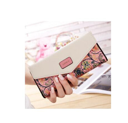 Woman holding a floral patterned clutch wallet, stylish accessory from FashionRay collection