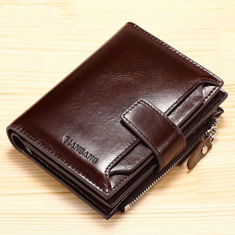 Brown leather wallet with clasp and zipper on light wood, FashionRay stylish accessory