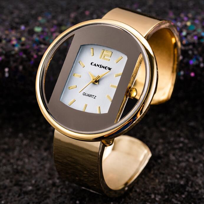 Gold-tone CANSNOW quartz women's watch with bold oval face, displayed on black background