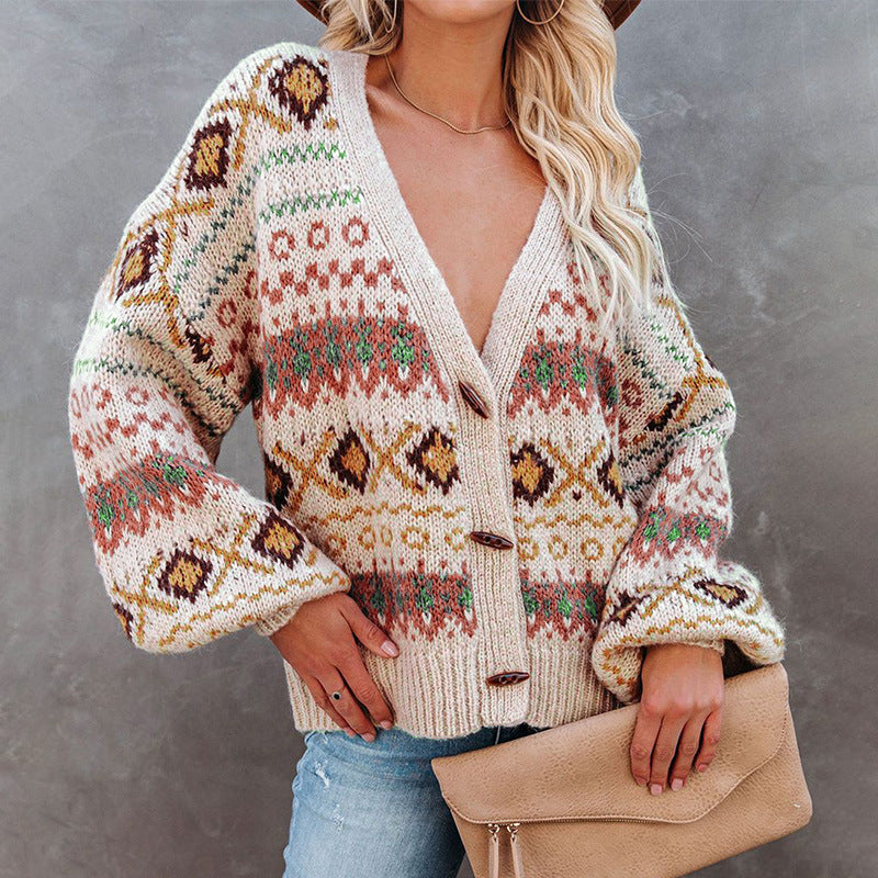 Woman in colorful patterned knit cardigan and jeans holding tan clutch, FashionRay style