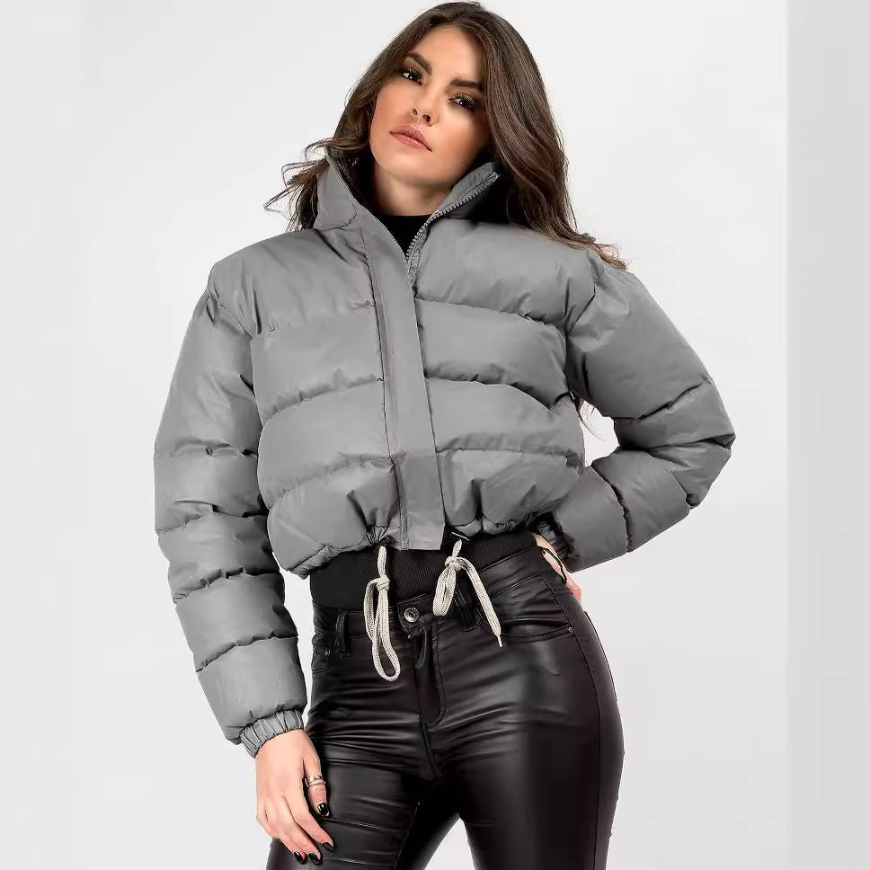 Woman wearing cropped gray puffer jacket and black faux leather pants, FashionRay style
