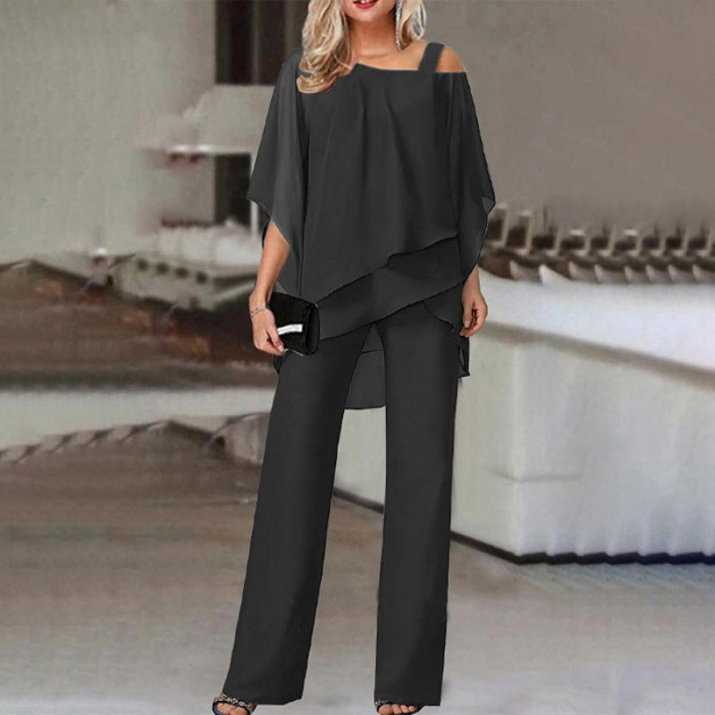 Woman in loose black off-shoulder pantsuit, FashionRay bold style, modern setting