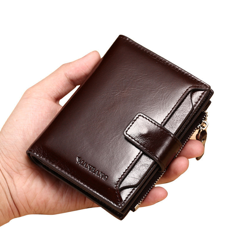 Hand holding a dark brown leather wallet with zipper and snap closure, FashionRay accessory