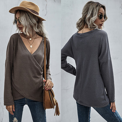 Woman in a brown waffle knit wrap sweater, jeans, and hat, showcasing FashionRay trendy style.