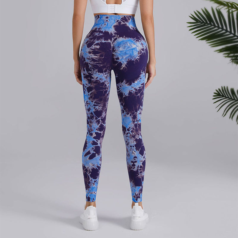 Woman wearing blue tie-dye leggings and white crop top, FashionRay trendy athleisure style.