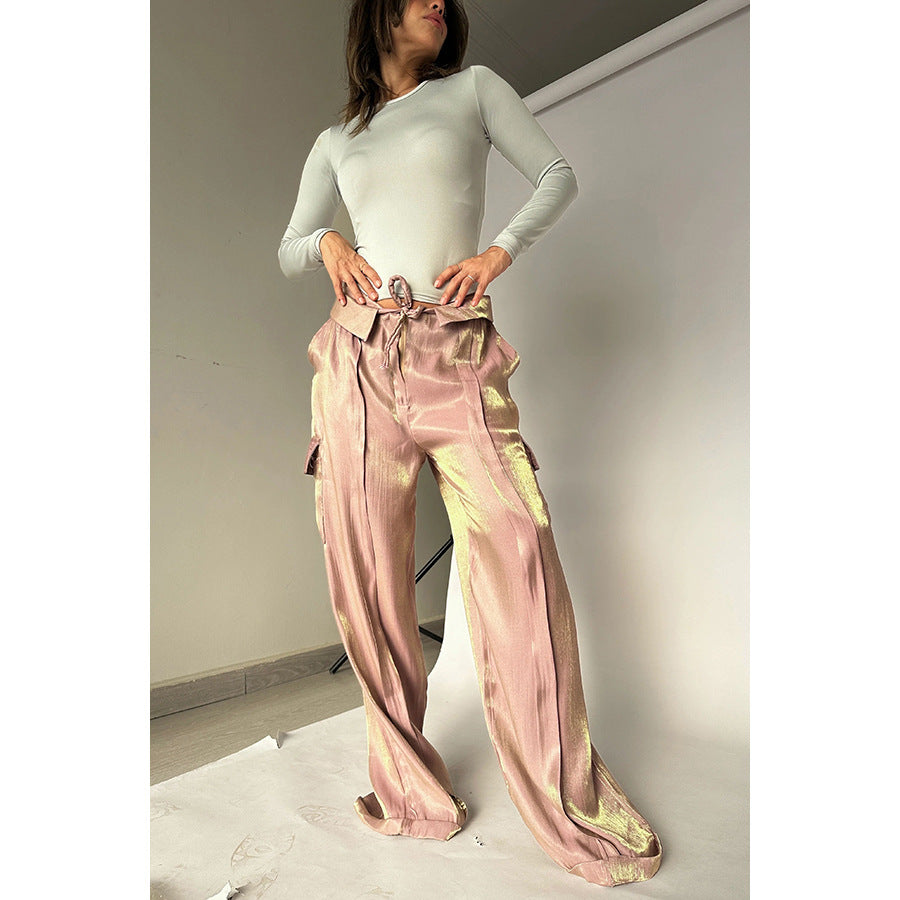 Woman modeling shiny pink gold wide-leg pants and fitted long sleeve top, FashionRay style