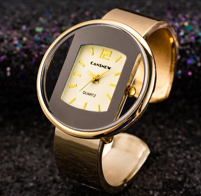Gold oval CANSNOW quartz watch with wide band on dark glitter background, FashionRay style