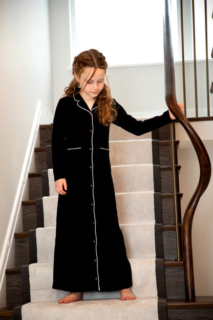 Girl in black long nightgown with white trim on staircase, FashionRay comfy sleepwear style