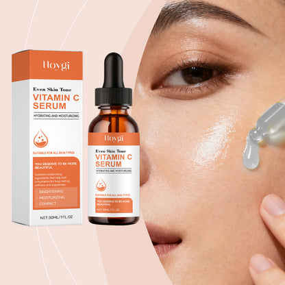 Hoygi Vitamin C serum bottle and packaging next to woman applying serum on glowing skin