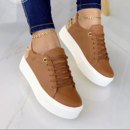 Brown leather platform sneakers with white soles from FashionRay, styled with gold anklets.