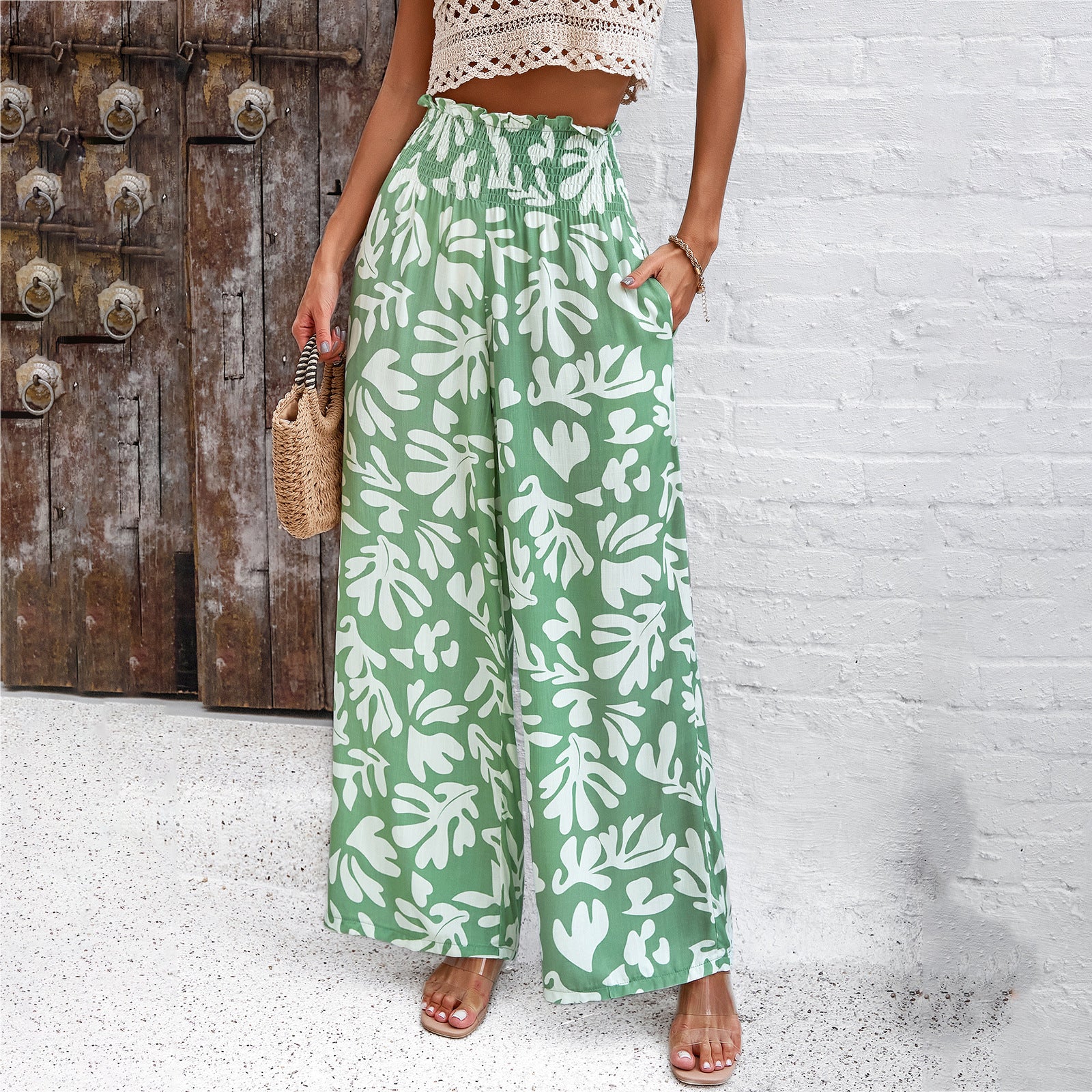 Trendy green wide-leg pants with white leaf print, paired with crochet crop top, FashionRay style