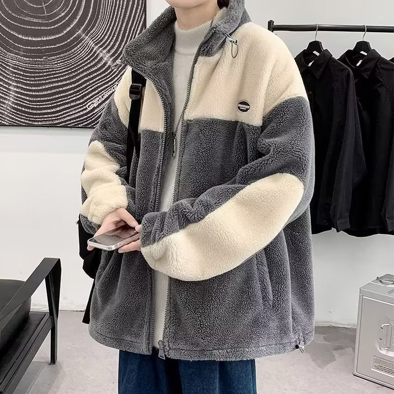 Person wearing a trendy gray and cream fleece jacket from FashionRay in a modern room