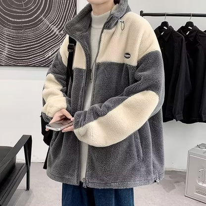 Person wearing a trendy gray and cream fleece jacket from FashionRay in a modern room