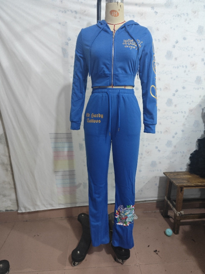 Blue two-piece tracksuit with hoodie and printed details on a mannequin, FashionRay trendy style
