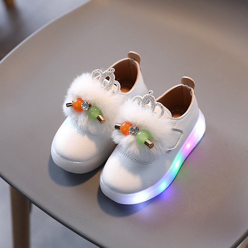 FashionRay kids white sneakers with fluffy crown detail and multicolor LED sole on chair