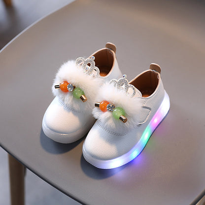FashionRay kids white sneakers with fluffy crown detail and multicolor LED sole on chair