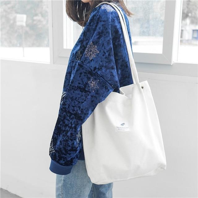 Woman in blue velvet star sweater with white canvas tote bag, FashionRay trendy style