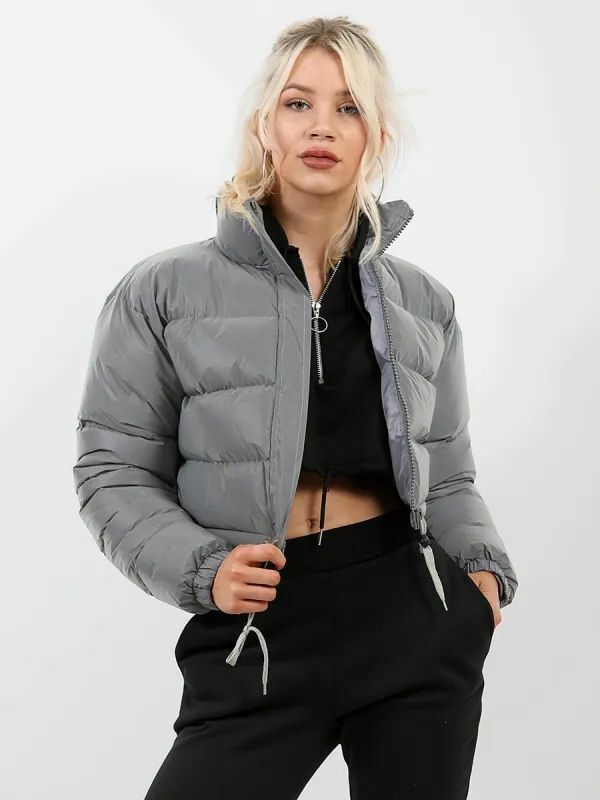 Woman wearing trendy gray puffer jacket and black crop top, FashionRay modern streetwear style