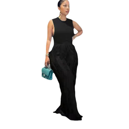 Woman in sleek black sleeveless maxi dress holding turquoise bag, FashionRay style