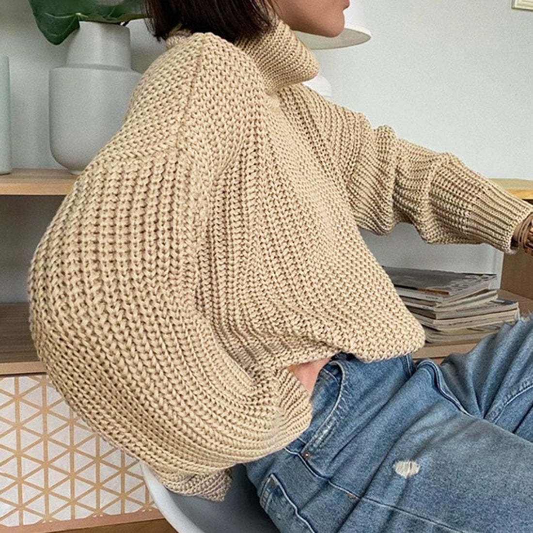 Woman in chunky beige knit turtleneck sweater and blue jeans, FashionRay cozy style