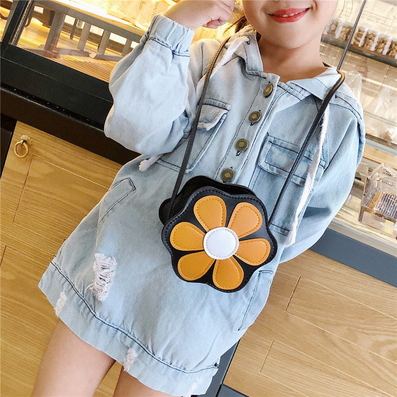 Girl in denim dress with yellow flower crossbody bag at FashionRay, trendy kids' accessory