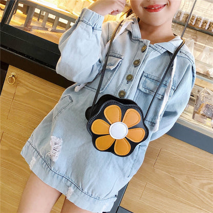 Girl in denim dress with yellow flower crossbody bag at FashionRay, trendy kids' accessory