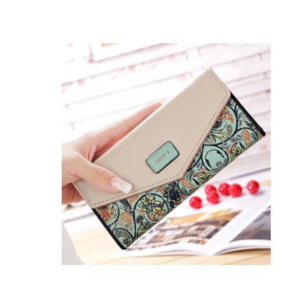 Hand holding FashionRay women's wallet with floral pattern and beige flap in modern setting