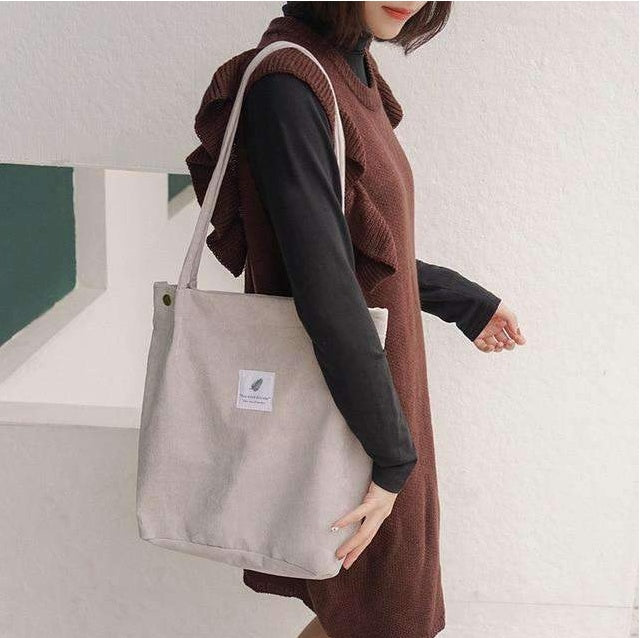 Woman in brown ruffle dress with beige canvas tote bag, FashionRay casual style