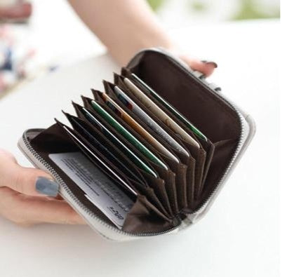 Woman holding an open zippered wallet with multiple card slots, FashionRay trendy accessory