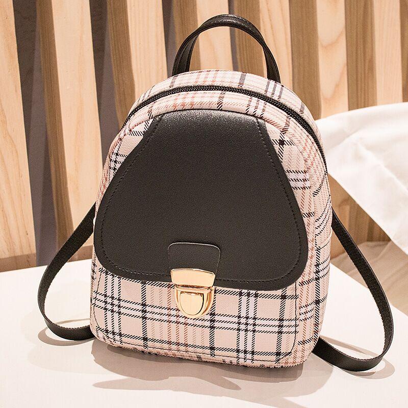 Trendy plaid mini backpack with black flap and gold clasp on table, FashionRay style