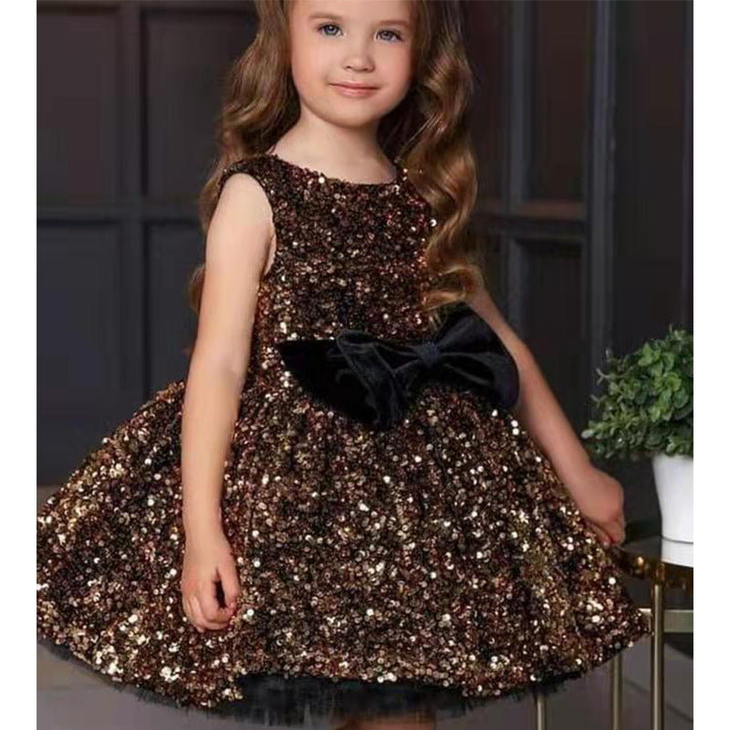 Young girl in a sparkly sequin party dress with a black velvet bow from FashionRay
