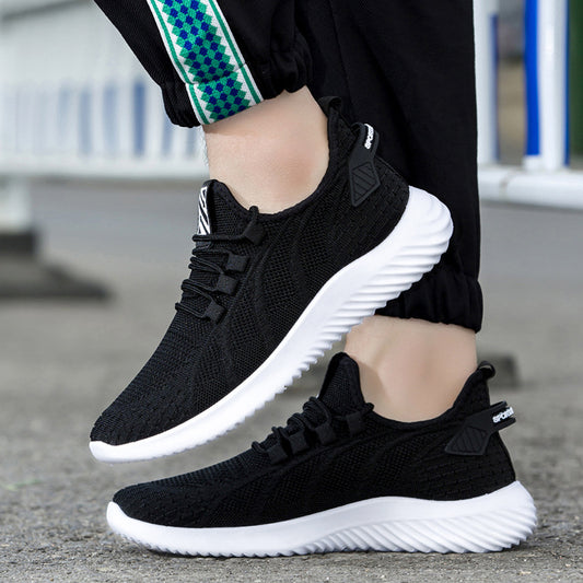 Black mesh sneakers with white soles, styled for comfort and fashion, worn outdoors