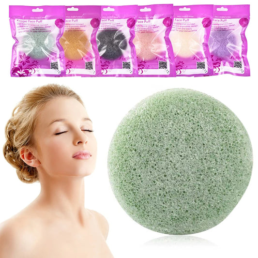 Woman with clear skin and closed eyes next to green konjac facial sponge, assorted puffs in background, FashionRay beauty skincare product.