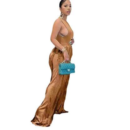 Woman wearing a bronze satin jumpsuit and holding a teal handbag, FashionRay style
