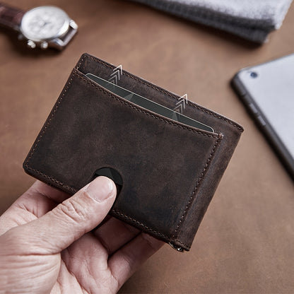 Hand holding a brown leather wallet with credit cards, stylish accessory on table