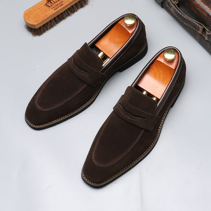 Dark brown suede penny loafers with wooden shoe trees, classic men's fashion footwear from FashionRay.
