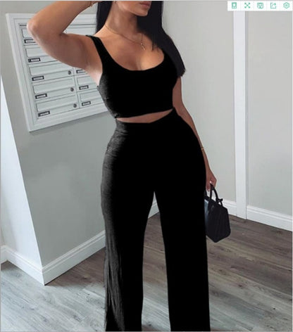 Woman in black sleeveless crop top and wide-leg pants, stylish outfit from FashionRay