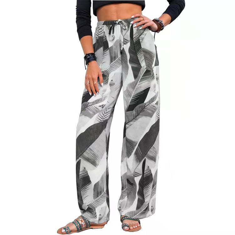 Woman wearing FashionRay black and white leaf print wide leg pants and crop top