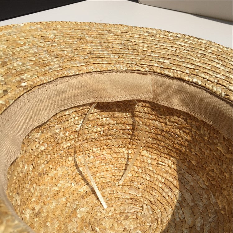 Close-up of straw sun hat interior with woven design and tan sweatband, FashionRay style