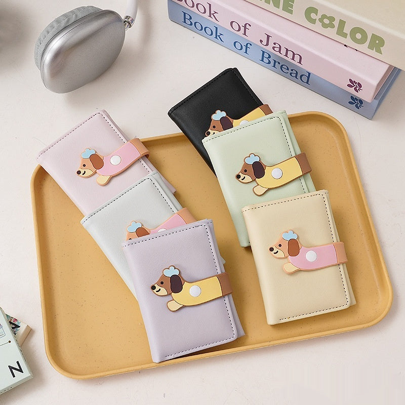 Cute pastel wallets with cartoon dog design on a tray, trendy accessories at FashionRay