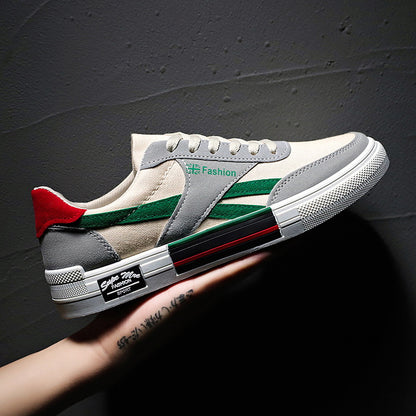 FashionRay trendy sneaker with green stripes, gray and red accents, held against a dark wall