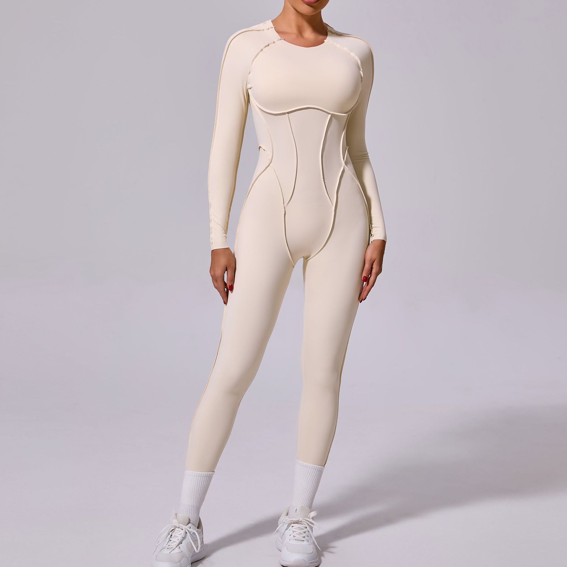 Woman modeling cream seamless long sleeve jumpsuit with sneakers, FashionRay style
