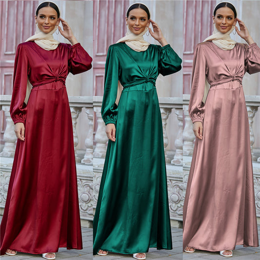 Woman modeling long satin dresses in red, green, and pink with cream scarf, FashionRay style.