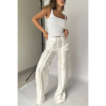 Woman modeling trendy white tank top and wide-leg satin pants in minimalist studio, FashionRay