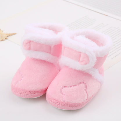 Pink plush baby booties with white faux fur trim, bear face embroidery, on FashionRay