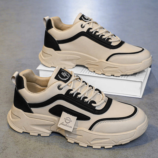 FashionRay beige and black chunky sneakers with bold sole on a gray floor