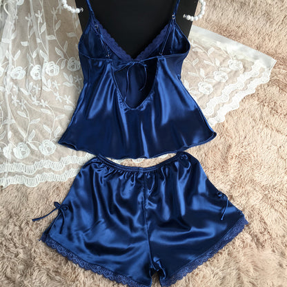 Navy blue satin lace pajama set with shorts, displayed on soft beige fur at FashionRay