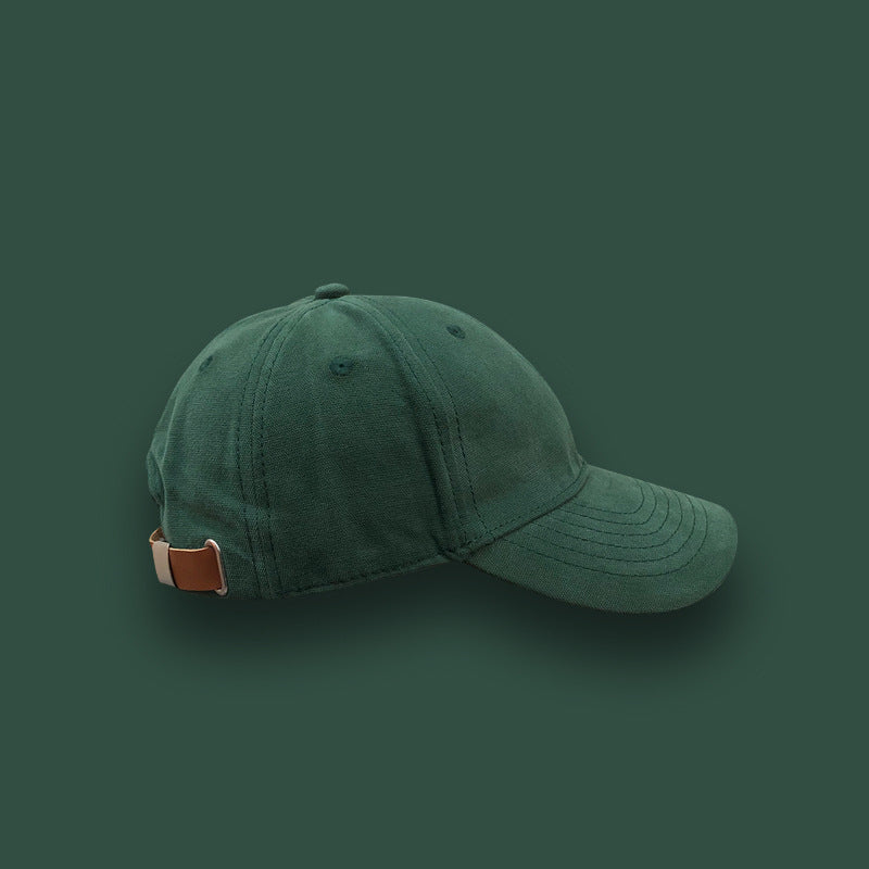 Dark green cotton baseball cap with adjustable strap on solid background, FashionRay style