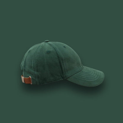 Dark green cotton baseball cap with adjustable strap on solid background, FashionRay style