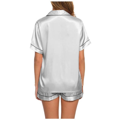 Woman wearing white satin short sleeve pajama set with black trim, FashionRay loungewear